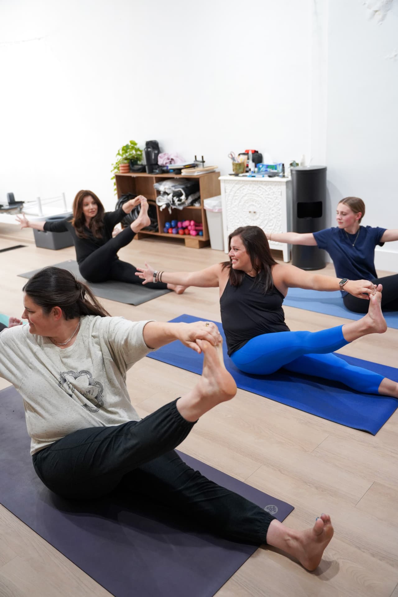 A group of students holding a seated balance together in the studio
