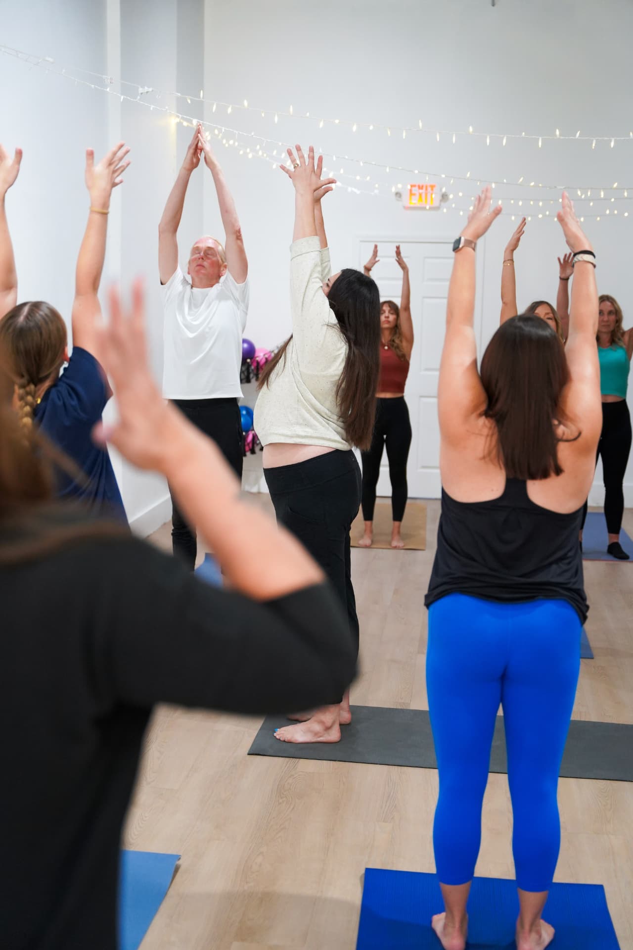 An all-levels vinyasa class reaching arms overhead together