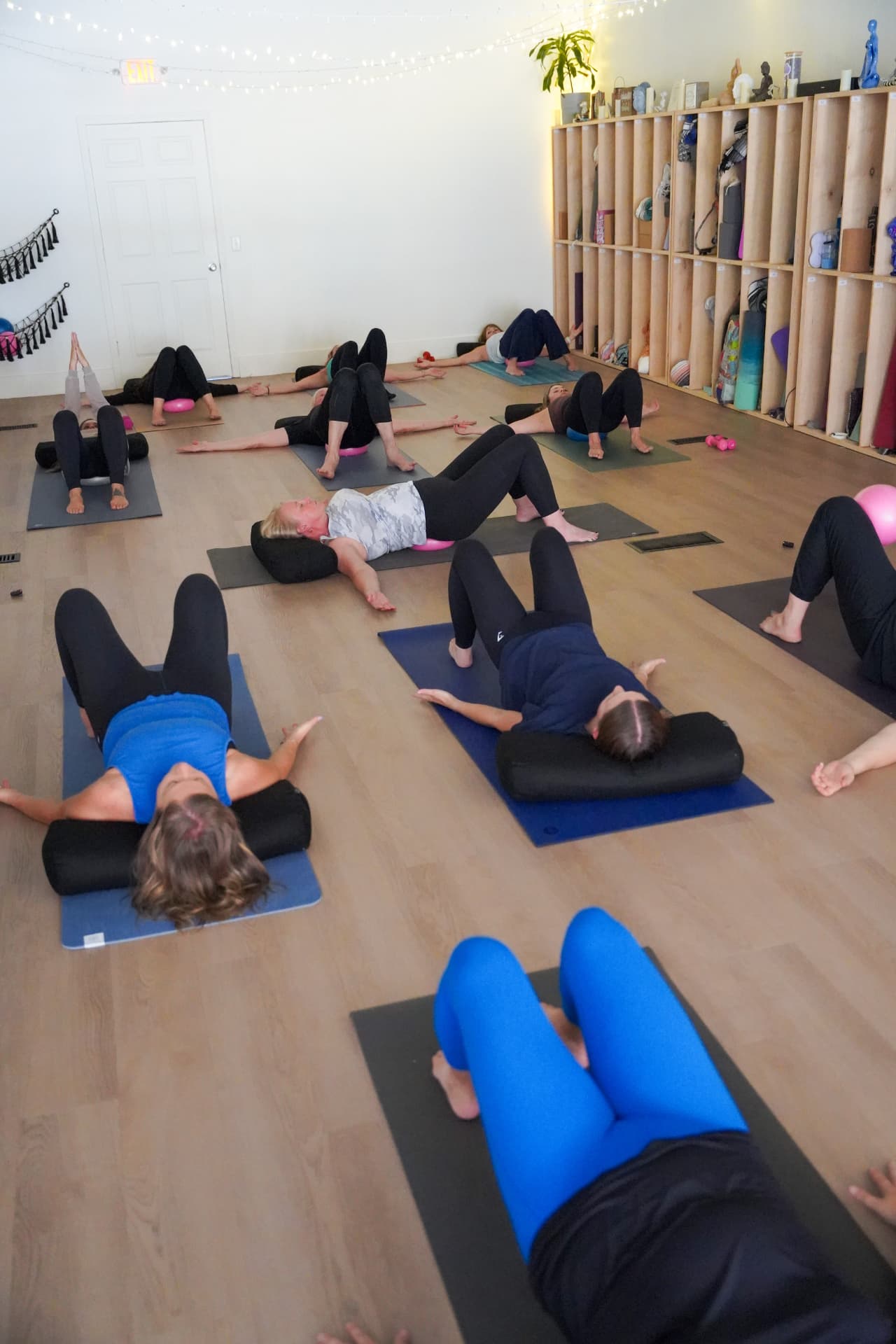 A small group practicing together with props during a booked session at Homegrown Yoga