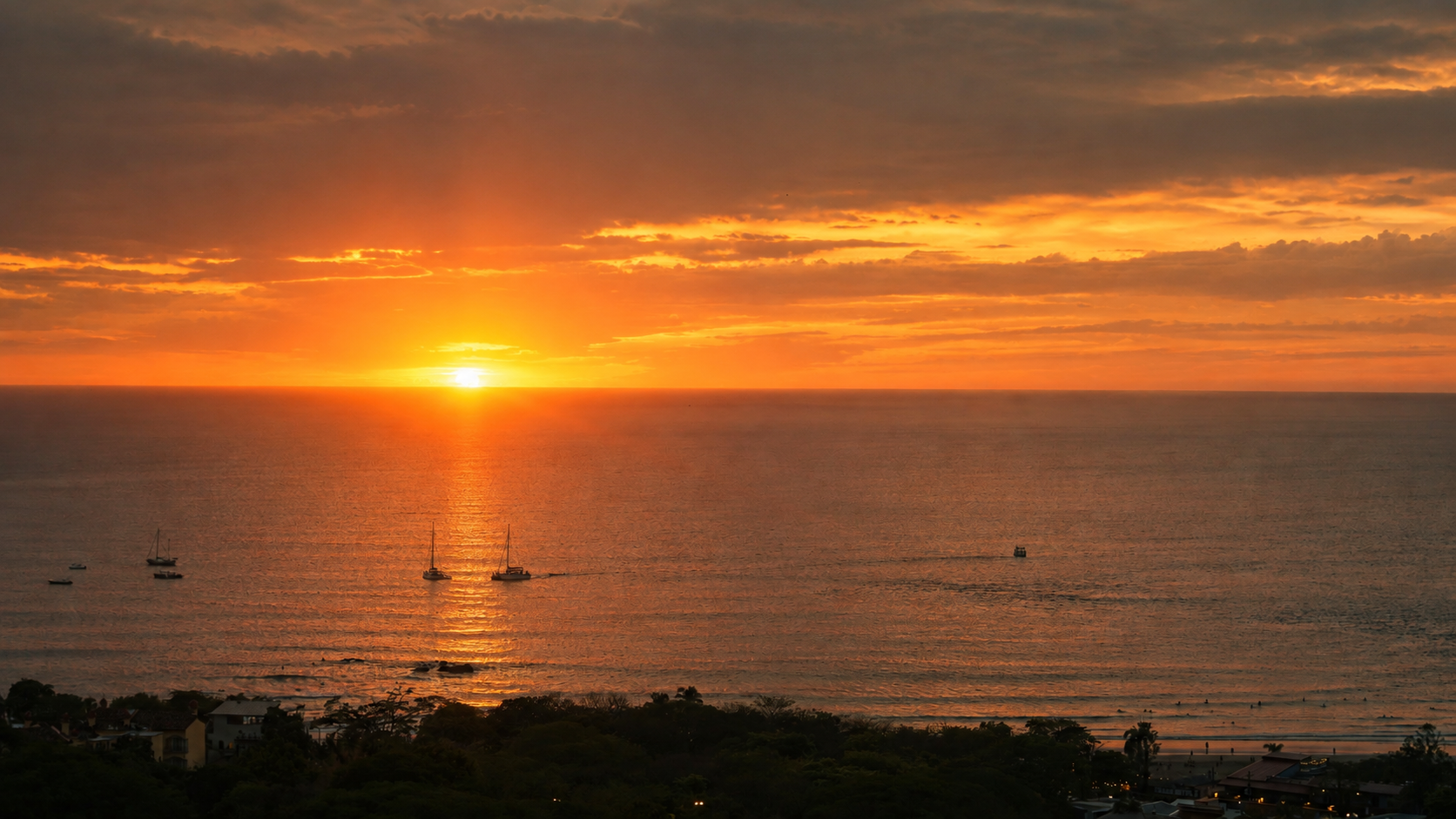 Sailboats on the water at sunset off the Costa Rican coast